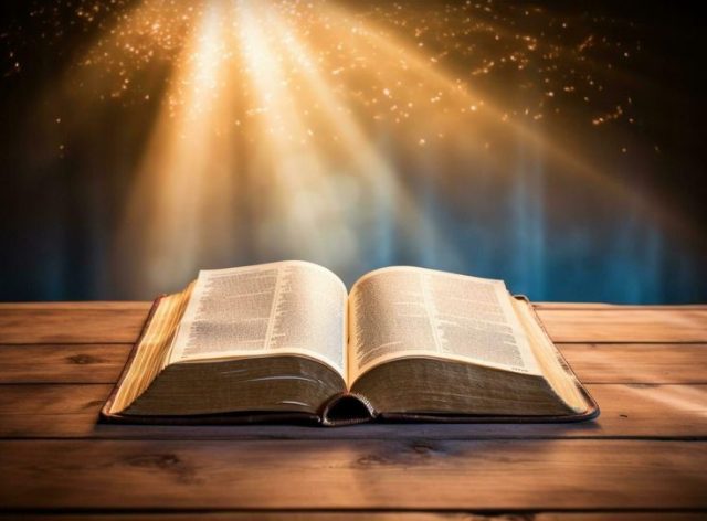 Open Bible with light shining on pages, surrounded by peaceful nature