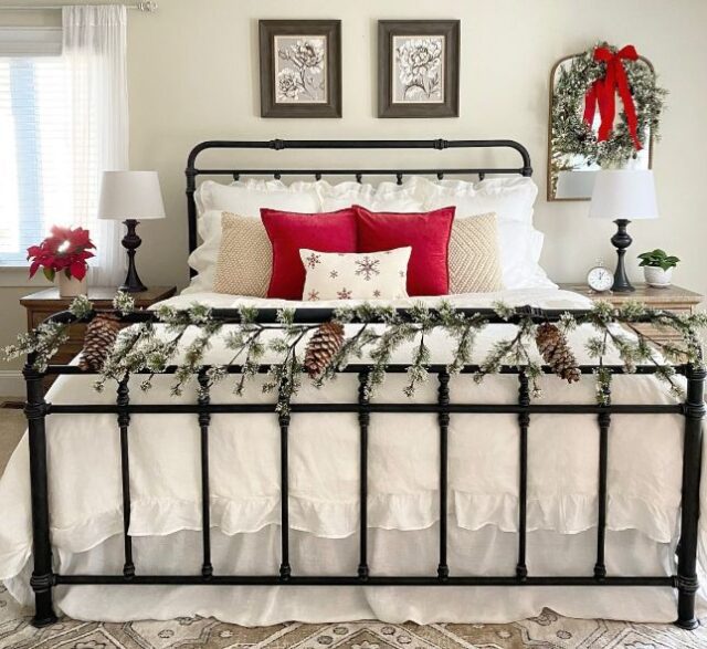 Modern Christmas bedroom with metallic accents — gold bedside lamps, silver ornaments, and cozy white bedding creating a chic festive glow